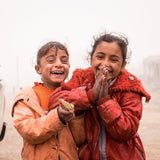 Laughing refugee kids smiling - help where needed most donation to Preemptive Love Coalition