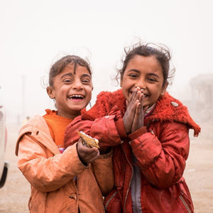 Laughing refugee kids smiling - help where needed most donation to Preemptive Love Coalition