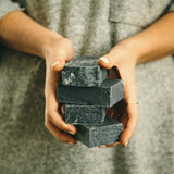 Woman holding refugee made charcoal soap