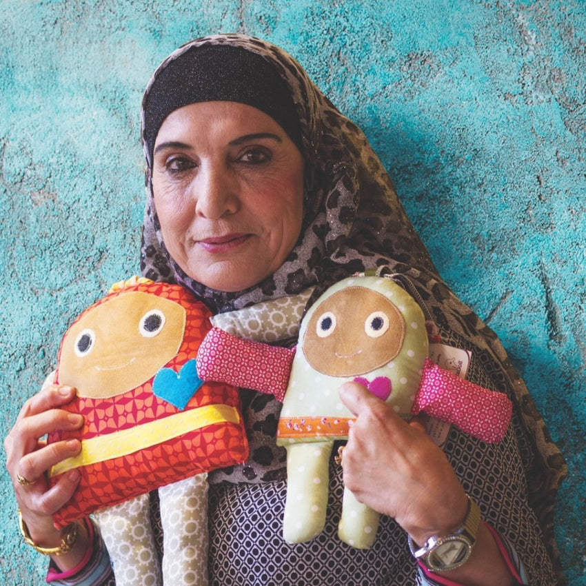 Woman holding knit dolls in Israel/Palestine